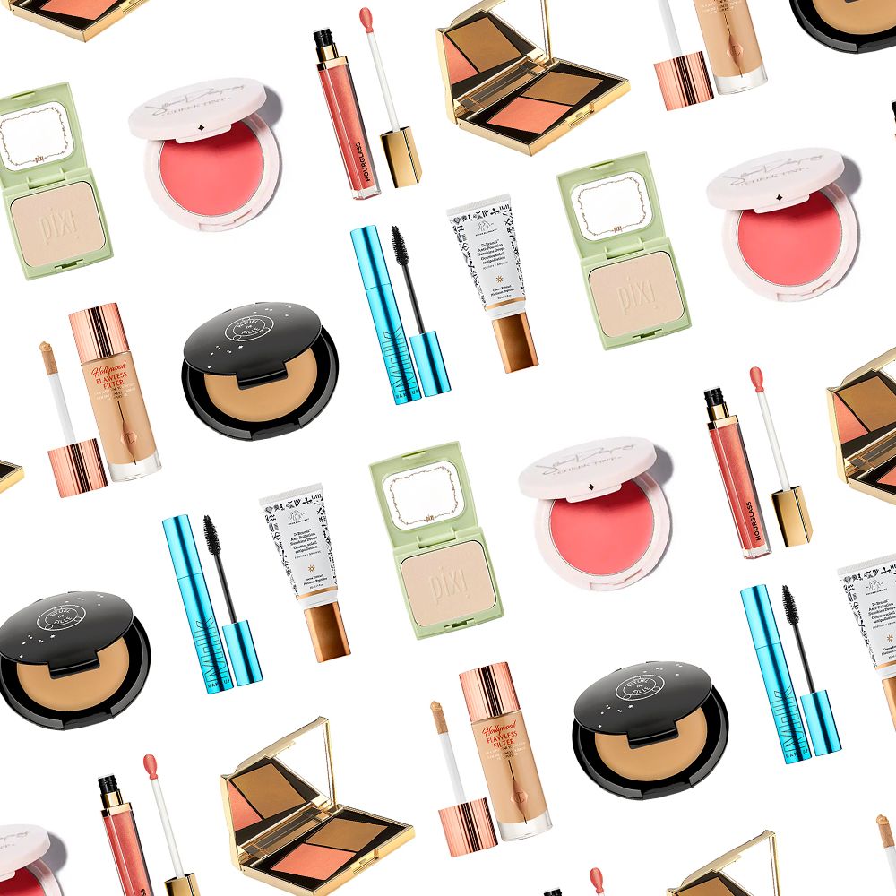 Assorted makeup products including blush, foundation, mascara, lip gloss, and contour palettes on white background.