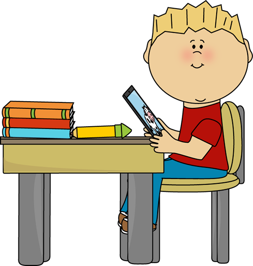 A smiling blond boy sits at a desk reading a tablet, with books and a pencil nearby.