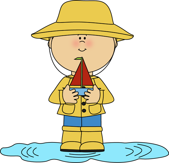 Child in yellow raincoat and hat holding a toy sailboat in a puddle.