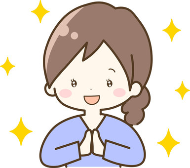 Smiling woman with brown hair in ponytail, hands clasped in gratitude, surrounded by yellow sparkles.