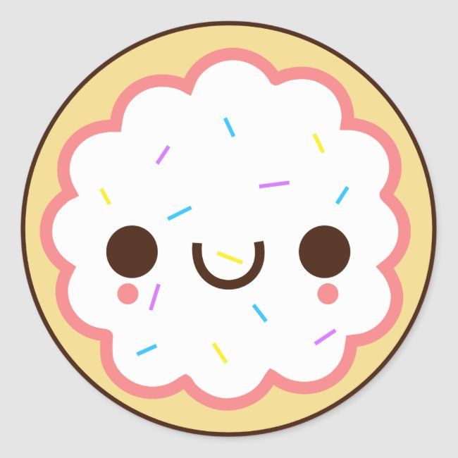 Cute kawaii-style frosted cookie with smiling face, sprinkles, and scalloped edges on a round plate.