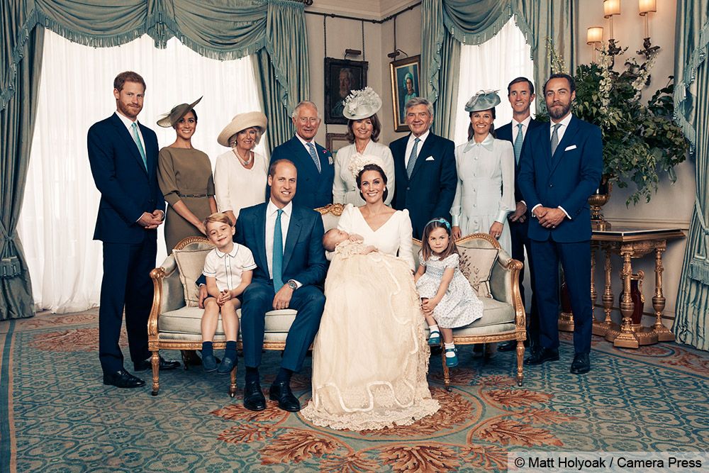 Royal family portrait featuring King Charles, Queen Camilla, Prince William, Kate Middleton, and children including Prince George and Princess Charlotte.