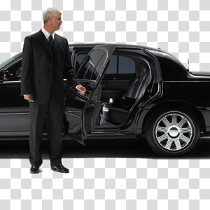 Professional chauffeur in black suit holding open door of luxury black sedan.