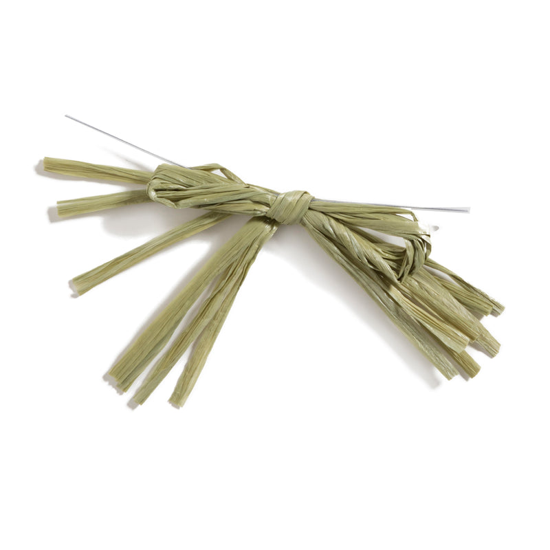 A hand-tied bow made of natural dried straw strands, secured with a thin metal wire, on a white background.