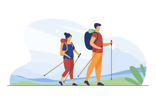 A man and woman hiking with backpacks and trekking poles against a mountain backdrop.