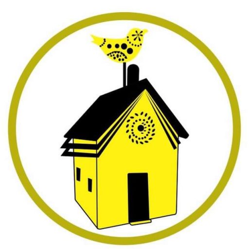 A stylized yellow house with a black roof and a decorative yellow bird perched on the chimney, enclosed in a green circle.