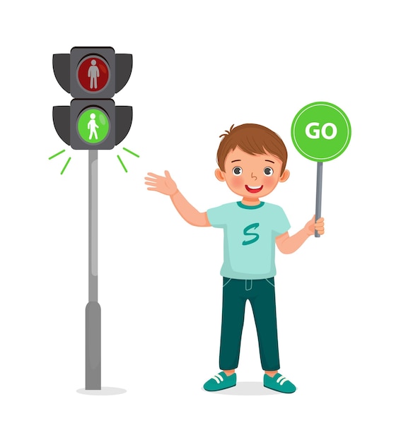 A smiling boy in a green shirt holds a "GO" sign next to a pedestrian traffic light showing green walk signal.