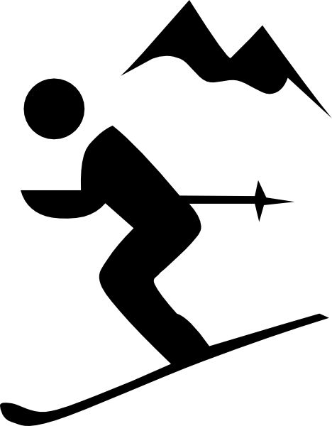 Silhouette of a skier in motion with mountain peaks in the background.