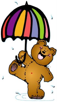 A cheerful brown teddy bear holding a rainbow-striped umbrella while standing in a puddle during light rain.