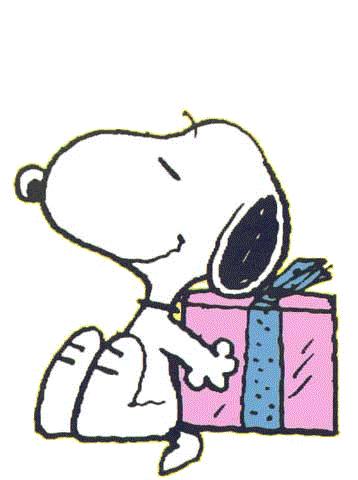 Snoopy sitting beside a pink gift box with blue ribbon, smiling contentedly.