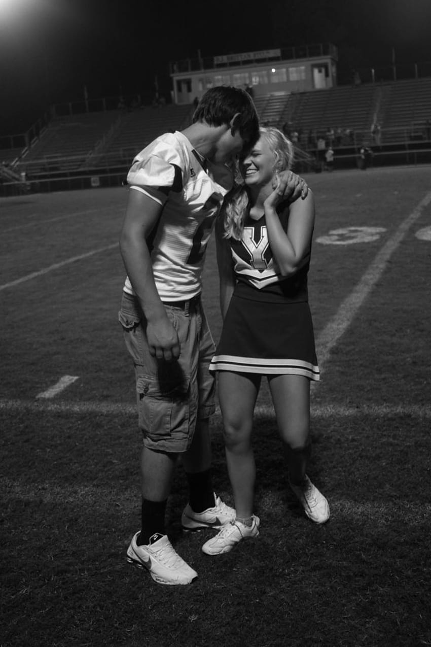 High School Football and Cheerleader Candid Moment on Field