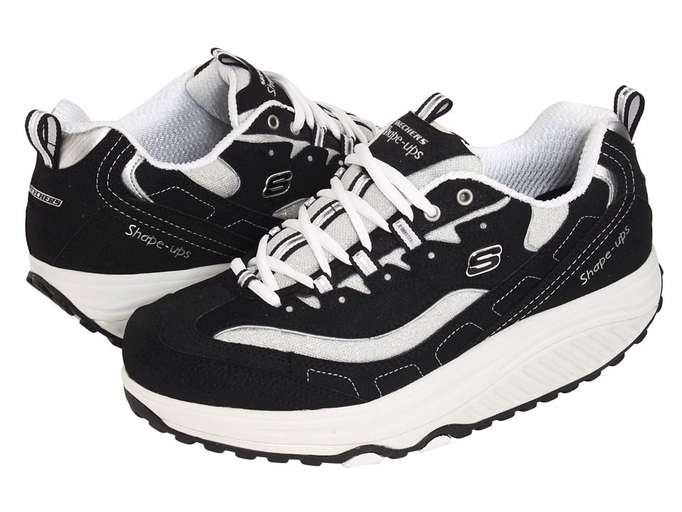 Black and white Skechers Shape-ups walking shoes with thick platform soles and lace-up design.
