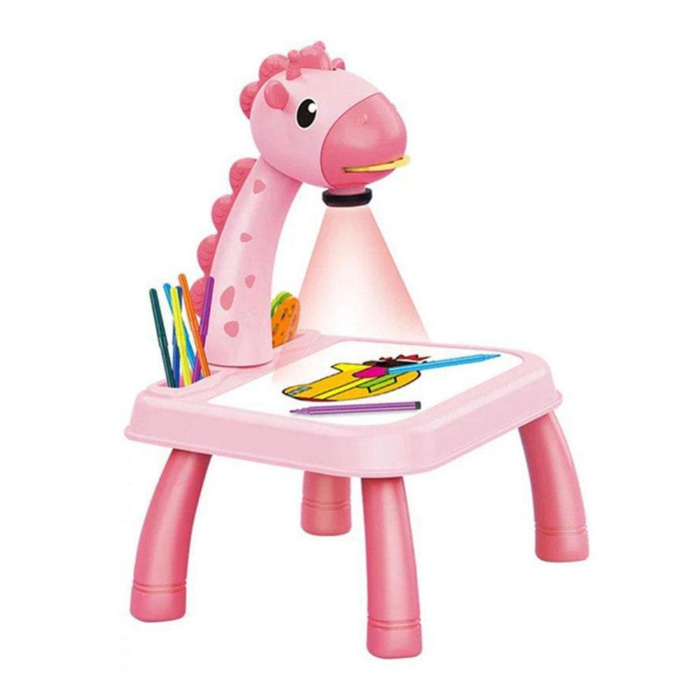 Pink giraffe-shaped kids drawing table with built-in projector, pens, and coloring sheet on white background.