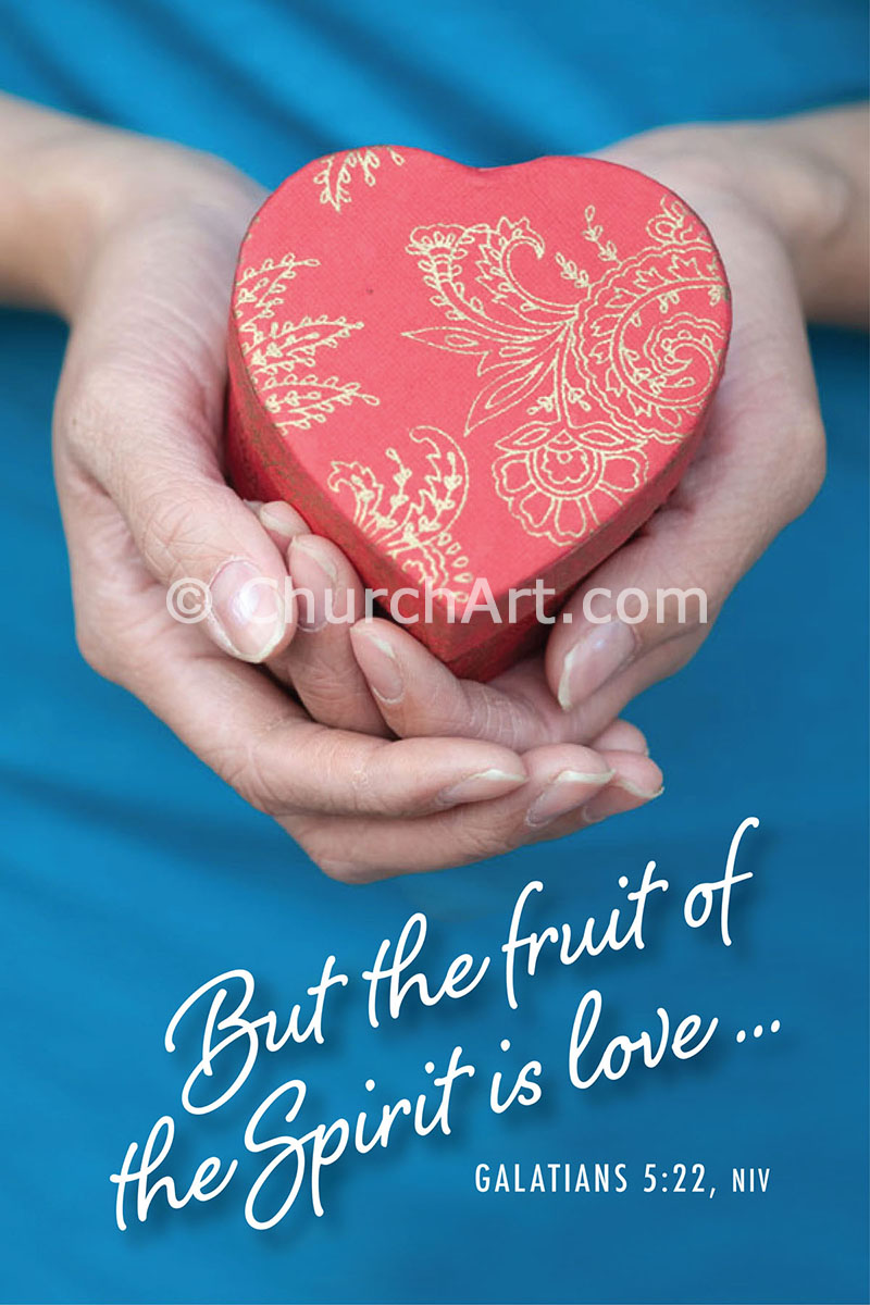 Hands holding a red heart-shaped box with gold floral patterns, against a blue background, with Galatians 5:22 text overlay.