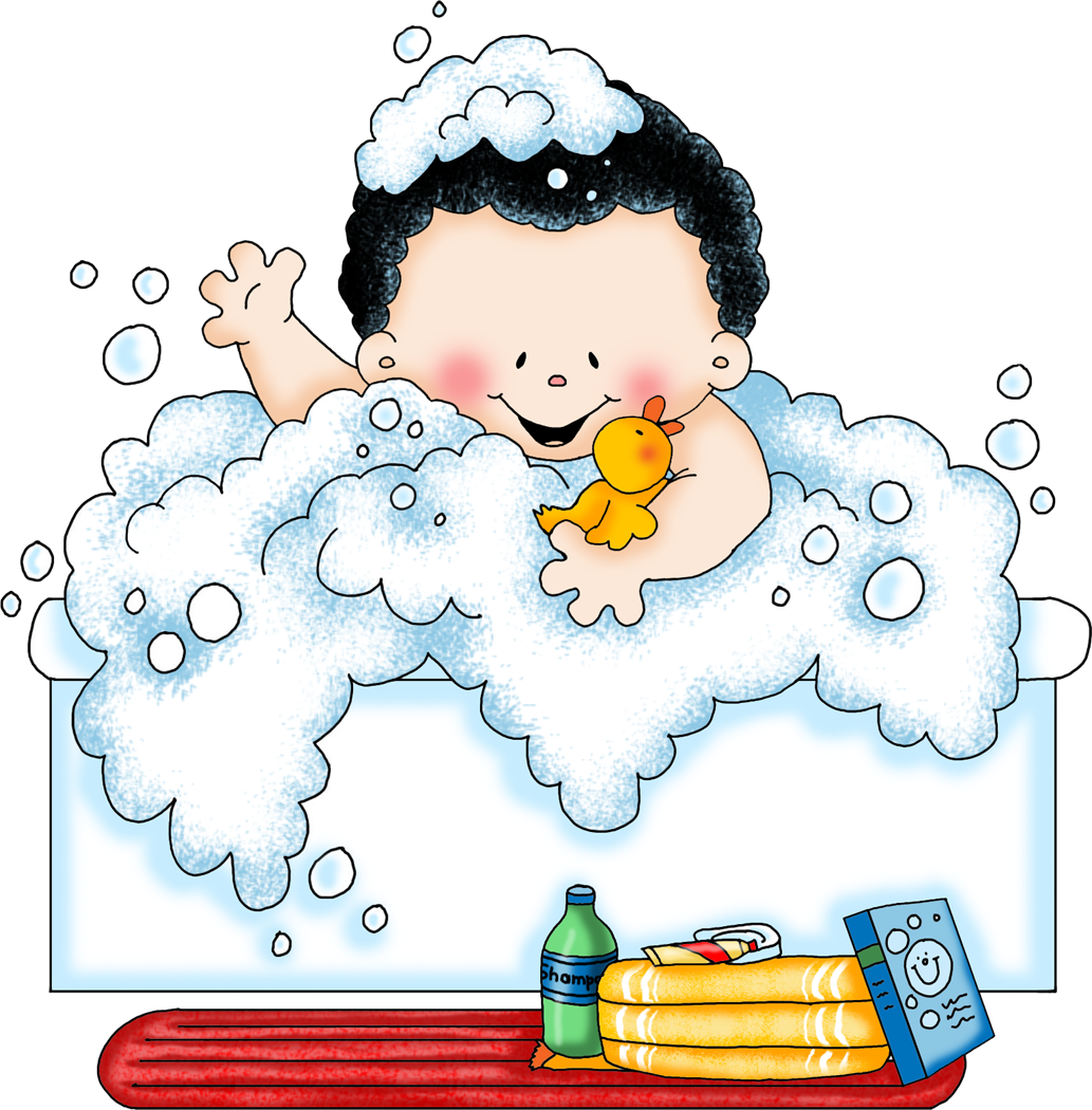 Happy baby with curly hair bathes in bubbly water, holding a yellow rubber duck, with shampoo and towels nearby.