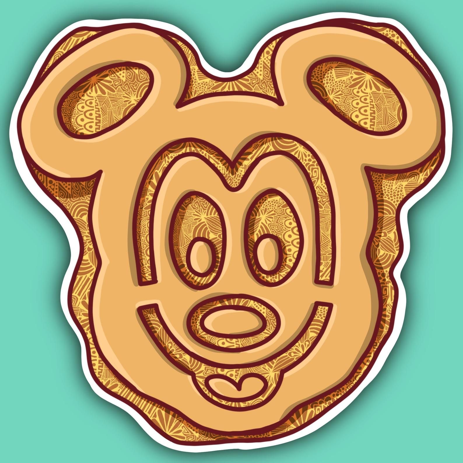 Stylized Mickey Mouse head shaped like a gingerbread cookie with intricate golden patterns and maroon outlines on teal background.