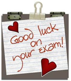 Handwritten "Good luck on your exam!" note with red hearts clipped to a clipboard.