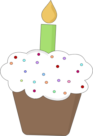 Birthday cupcake with white frosting, colorful sprinkles, and a single green candle with yellow flame.