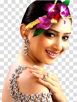 Indian woman in traditional floral hair adornment and ornate silver jewelry, smiling softly.