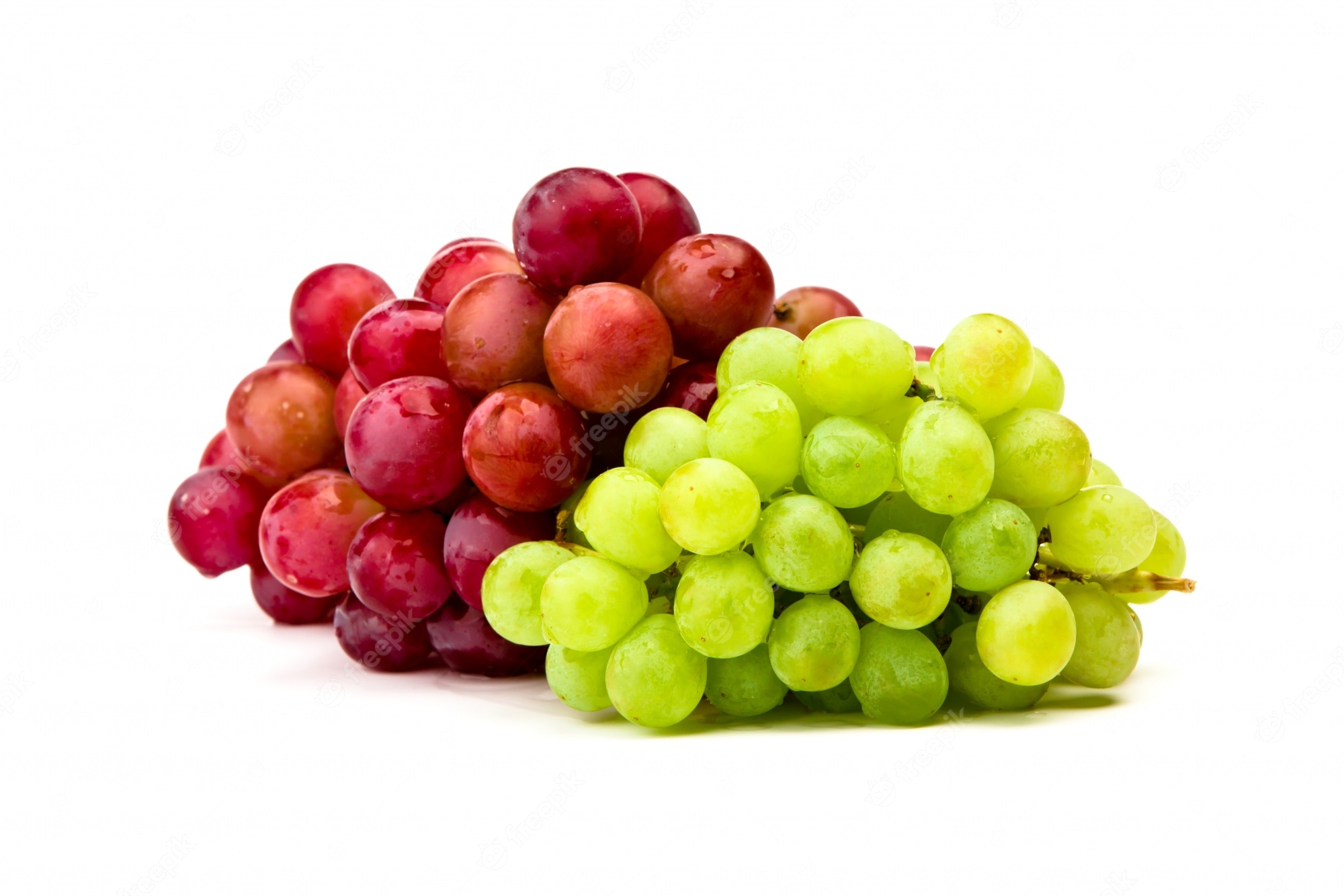 Fresh red and green grapes clustered together on a white background, glistening with moisture.