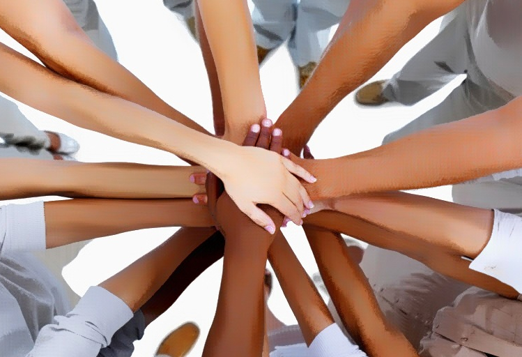 Diverse group of people stacking hands in unity, symbolizing teamwork and collaboration.