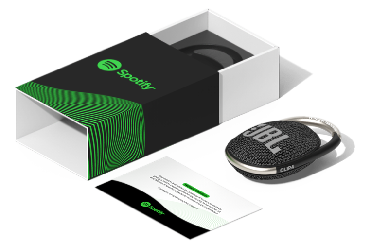 Spotify-branded box with JBL Clip 4 portable speaker and welcome card on white background.