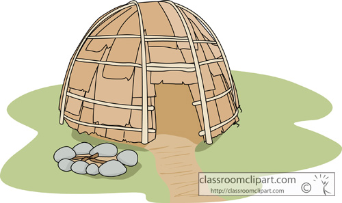 A traditional dome-shaped Native American wigwam made of wooden poles and bark, with a stone fire pit nearby on grassy ground.