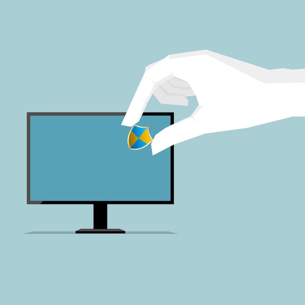 A white hand places a blue-and-yellow shield icon onto a computer monitor screen, symbolizing digital security or antivirus protection.