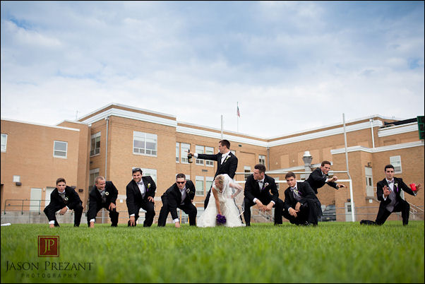 Creative Wedding Group Photo with Groomsmen in Playful Pose