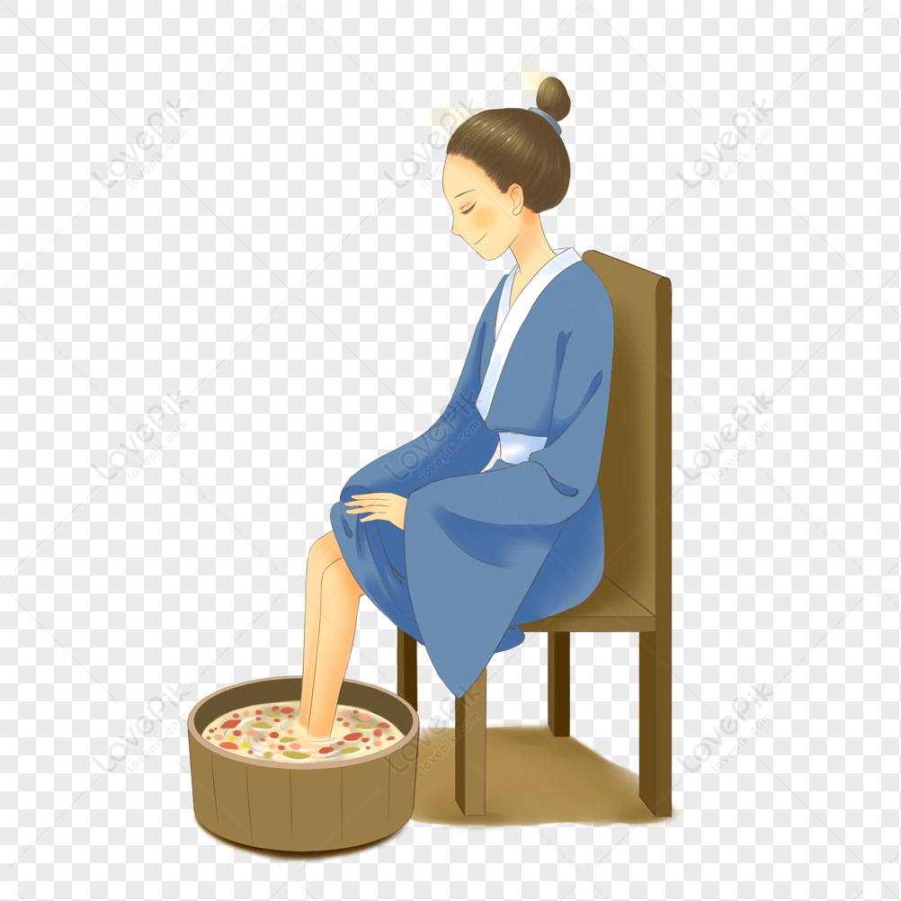A woman in a blue robe sits on a wooden chair, soaking her feet in a herbal foot bath with steam rising.