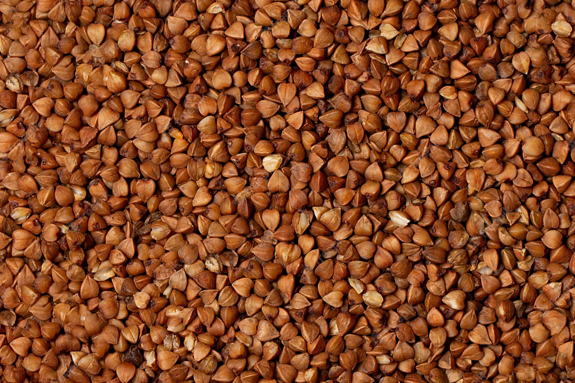 Close-up of roasted buckwheat groats, showcasing their triangular shape and rich brown tones.