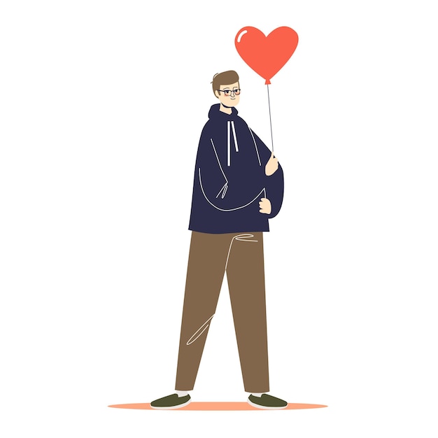 Young man in navy hoodie and brown pants holding a red heart-shaped balloon.