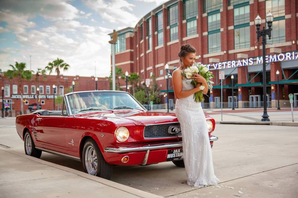 Elegant Wedding Photo with Classic Red Mustang at Veterans Memorial Arena