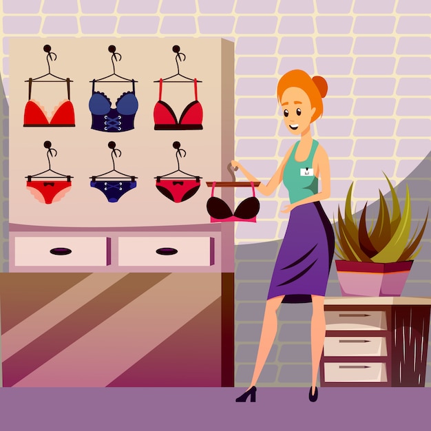 A smiling woman in a lingerie store holds a black bra, with colorful bras and panties displayed on the wall behind her.