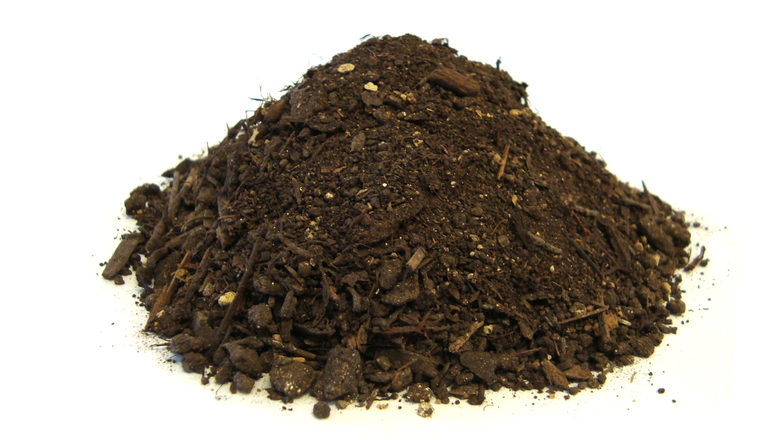 A mound of rich, dark compost with visible organic matter like wood chips and soil particles on a white background.