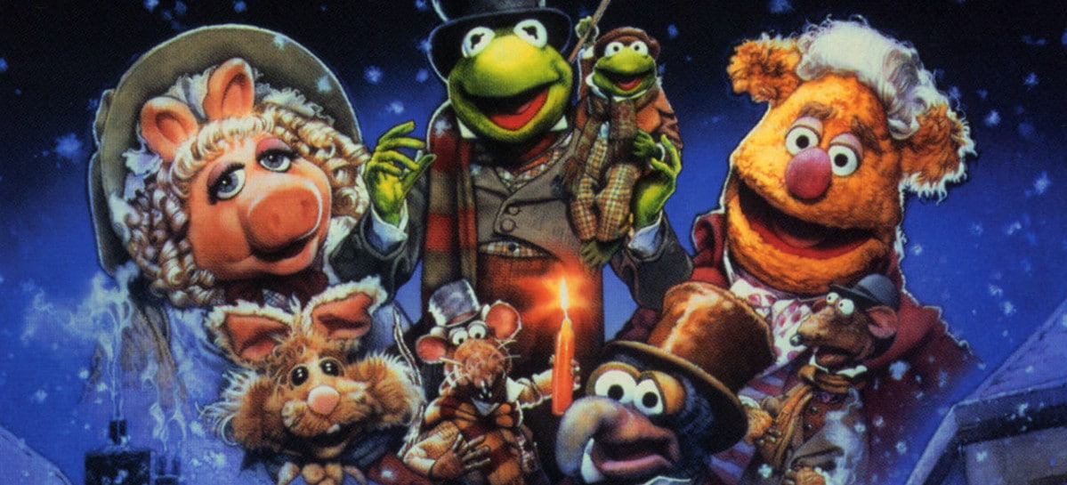 Kermit, Miss Piggy, Fozzie, Gonzo, and other Muppets in Victorian-era Christmas attire against a snowy night backdrop.