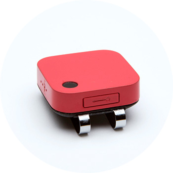 Red compact GPS tracker with metal clip attachment and power button.