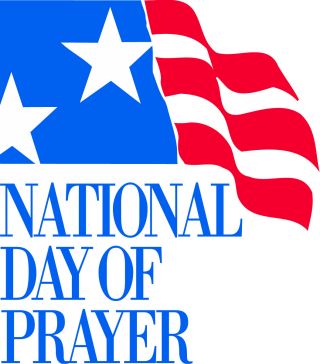 National Day of Prayer logo featuring a waving American flag with stars and stripes and bold blue text.