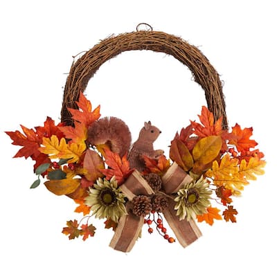 Autumn wreath with grapevine base, fall leaves, sunflowers, pinecones, berries, and a squirrel accent.
