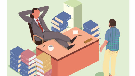 A relaxed businessman reclines in an office chair with feet on desk, surrounded by stacks of books and files, as a colleague approaches.