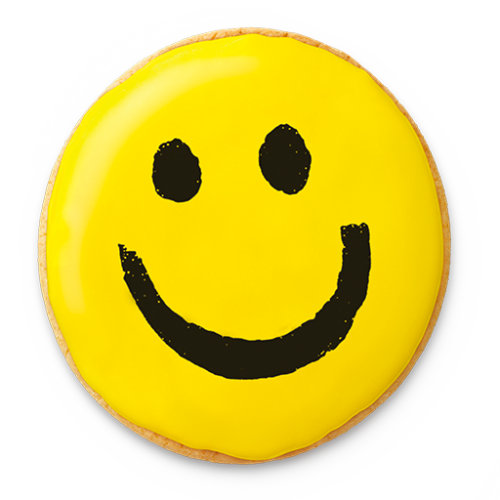 A bright yellow frosted cookie decorated with a classic black smiley face design.