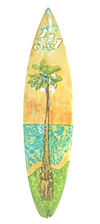 Hand-painted surfboard featuring a palm tree, turquoise ocean, and green shore with abstract wave motifs and stylized script at the nose.