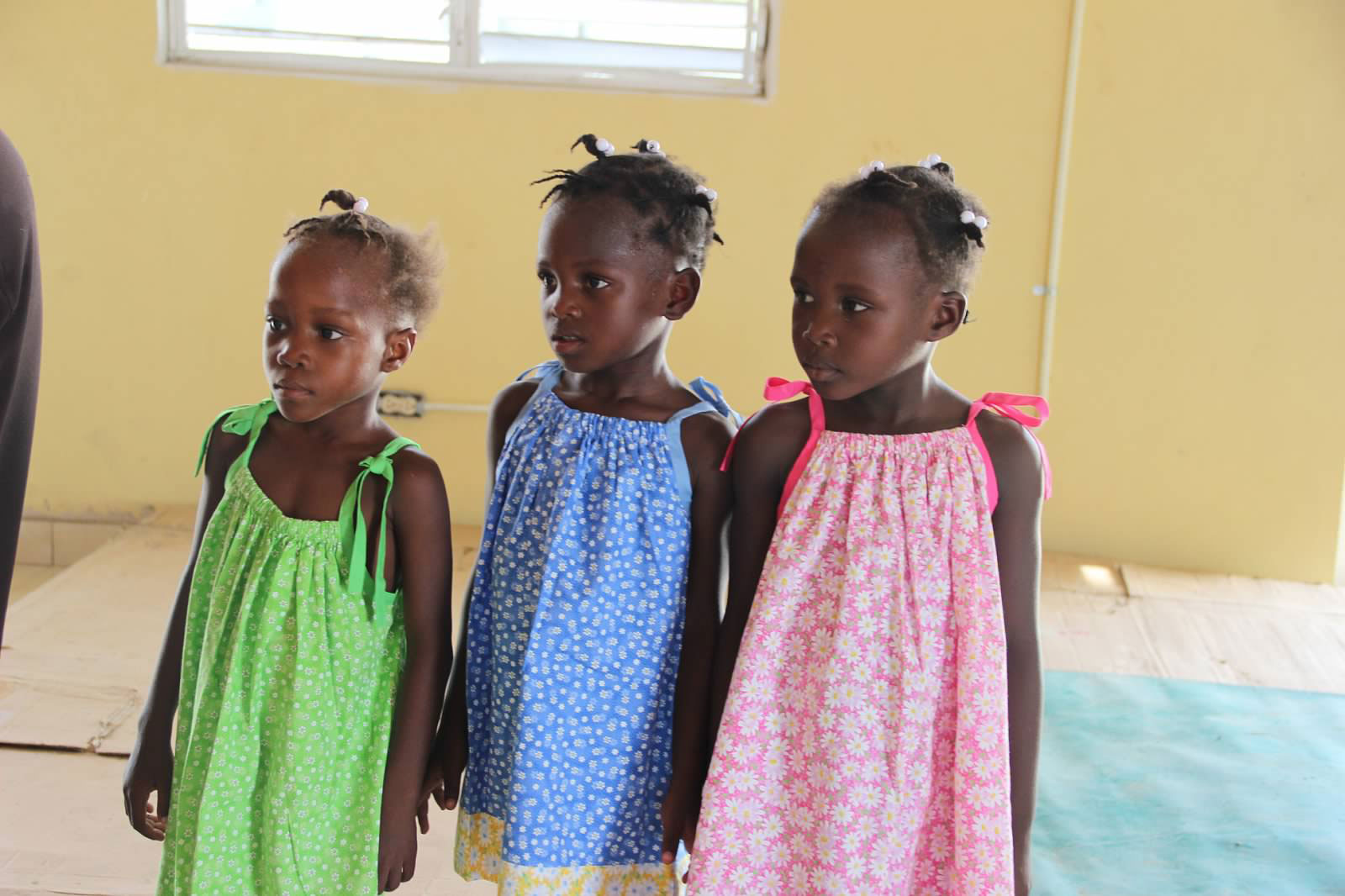 Children in Colorful Dresses at Community Center - Hope and Resilience
