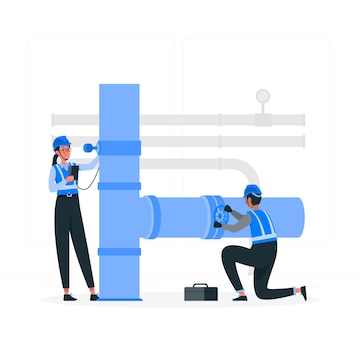 Two technicians in blue uniforms inspect and repair large industrial pipes with tools and a toolbox nearby.