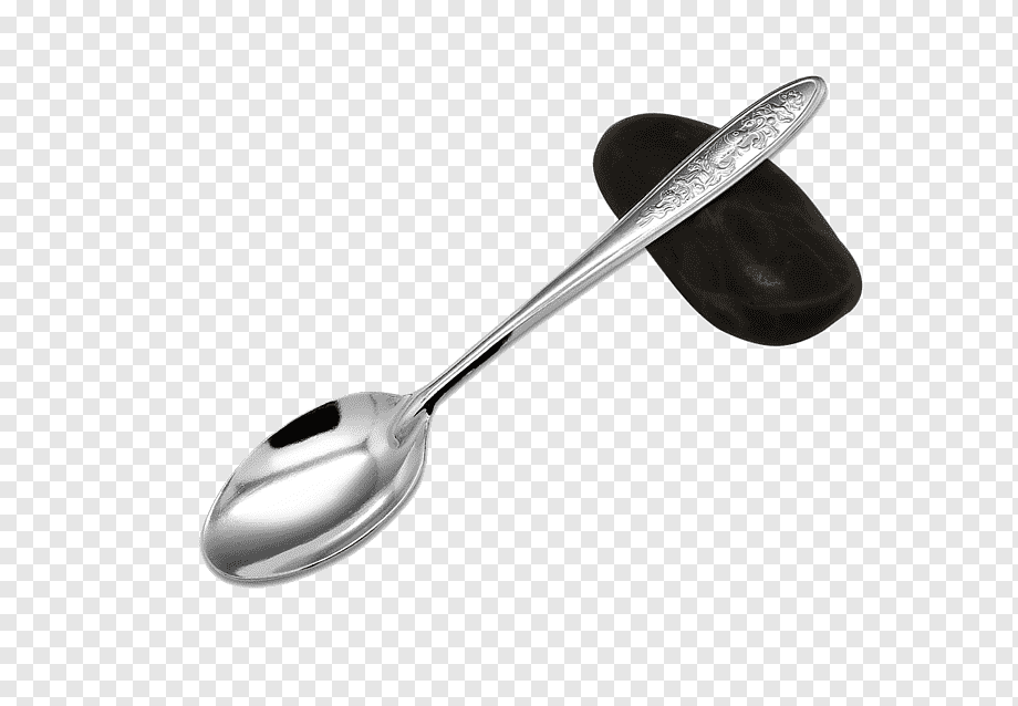 Polished stainless steel spoon with ornate handle resting on a smooth black stone against transparent background.