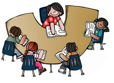 Children reading books together around a U-shaped table with a teacher guiding them.