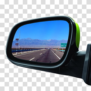 Car side mirror reflecting a clear highway with mountains and blue sky in the background.