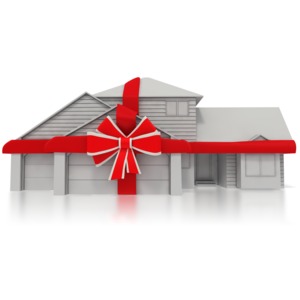 Gray two-story house wrapped in a red gift ribbon and bow, symbolizing a home as a gift or real estate promotion.