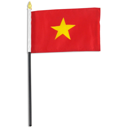 Vietnamese national flag on a handheld stick with golden spearhead finial, red field and yellow five-pointed star.