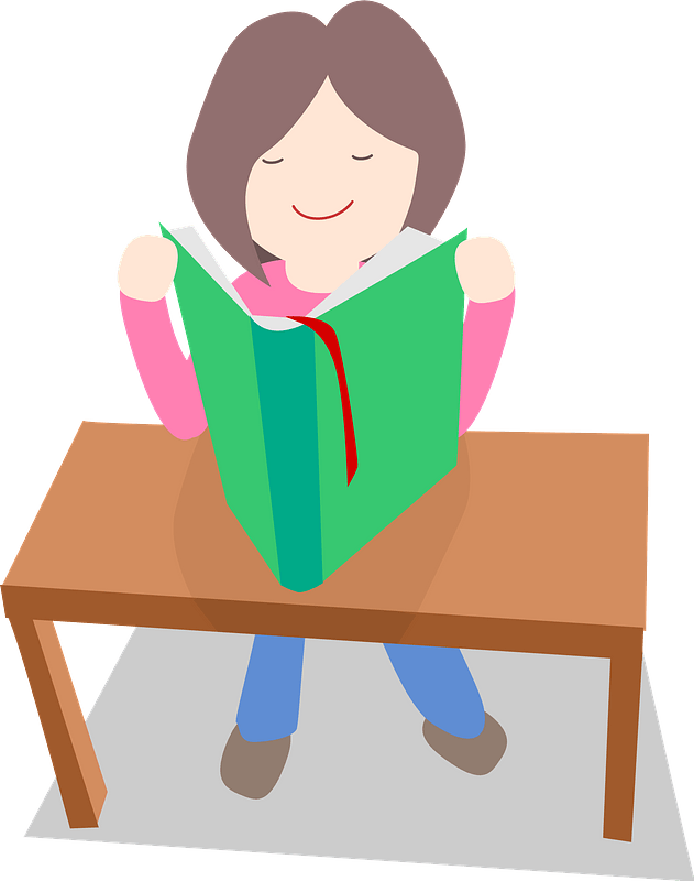 A smiling woman with brown hair sits at a wooden table, reading a green book with a red bookmark.